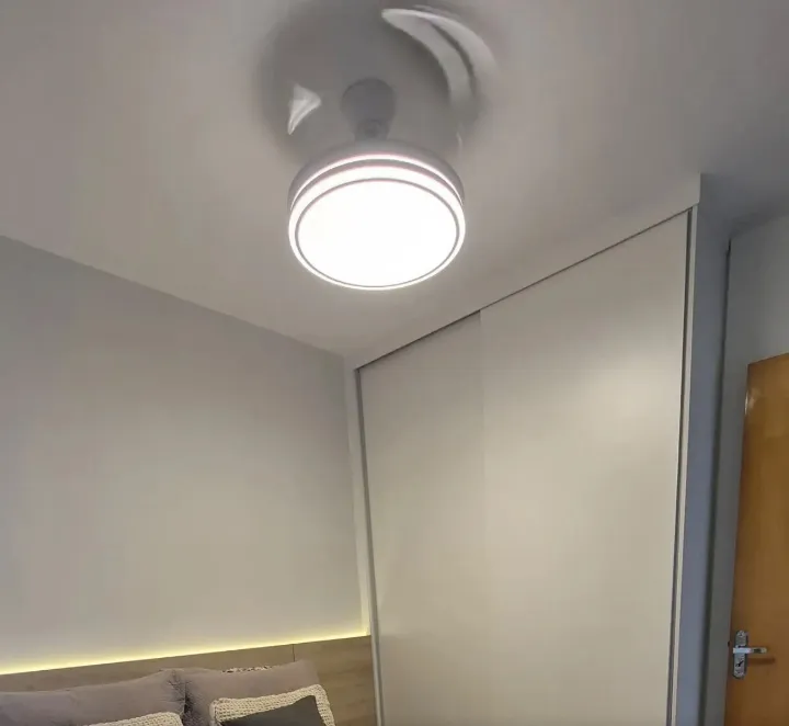 Ventilador de techo blanco encendido en un dormitorio